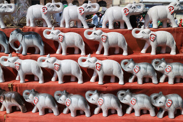 Many white elephants on a red background. Souvenir shop in Puri, Orissa, India.