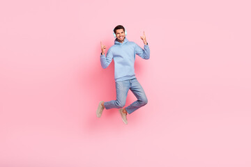 Fototapeta na wymiar Photo of attractive funky man wear blue stylish clothes listening heavy metal rock isolated on pink color background