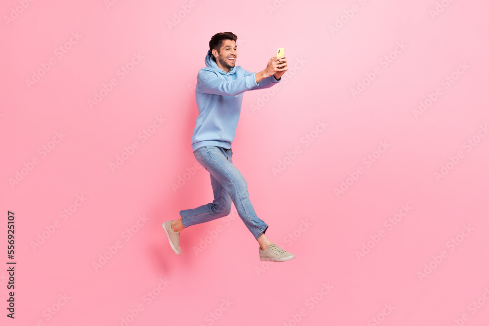 Poster full length photo of crazy cheerful man blogger chatting followers subscribers make selfie empty spa