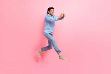 Fototapeta na wymiar Full length photo of crazy cheerful man blogger chatting followers subscribers make selfie empty space isolated on pink color background