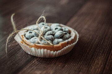 Blueberry goat cakes with blue berries on dark vintage backgroun