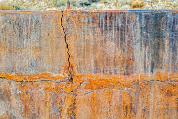 Cracks in the outer wall of a concrete bin at an abandoned mine in Nevada, USA