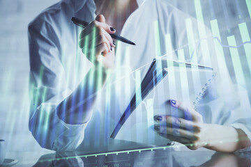 Financial chart drawn over hands taking notes background. Concept of research. Multi exposure