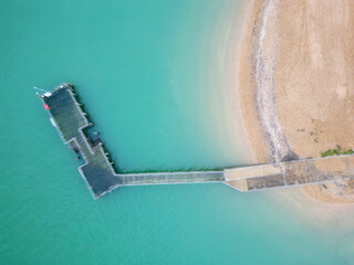 The pier goes into the sea, without people, top view