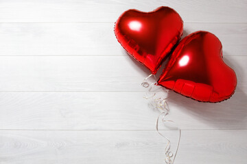Valentine red heart shape balloon on white wooden background. Top view, copy space valentine's...