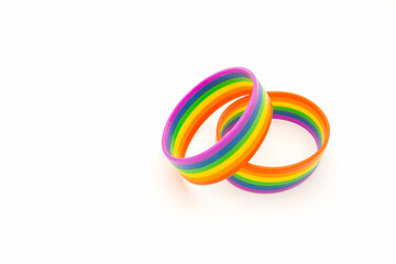 Rainbow patterned wristbands are on a white background