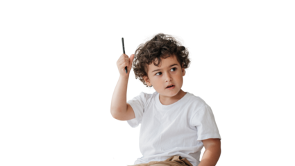 Thoughtful little curly caucasian boy sitting holding pencil looking aside against transparent background. Preschooler Spanish kid learning letters at home. Knowledge, home studying. Childhood concept
