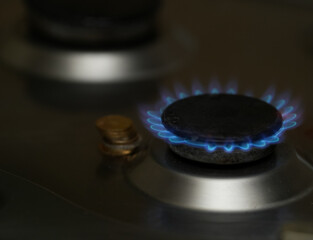 Natural gas burning a blue flames on black background