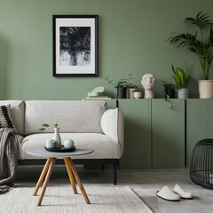 Elegant living room interior design with mockup poster frame, modern grey sofa, wooden commode, folding screen, plants and stylish accessories. Eucalyptus wall. Template. Copy space.
