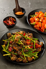 Plate of fried garlic arrows with meat. Traditional Chinese food.