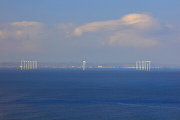 Fototapeta premium Distant view of a offshore wind farm off the coast of teeside, North east England, UK.