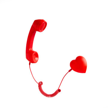 Retro red telephone handset connected to red heart on white background. Pop art, Vintage aesthetic 80s or 90s. Love communication, romantic message, valentine day.
