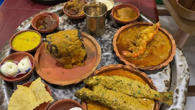 Bengali food thali in Kolkata. Bengali thali for puja and Pailaboishakh. Bengali Thali with Vegetables , Chicken , Prawn, Ilish and Sweets. design for banner. Restaurant food.