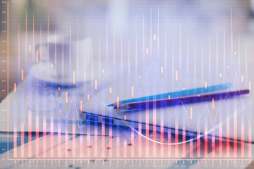 Forex graph hologram on table with computer background. Double exposure. Concept of financial markets.