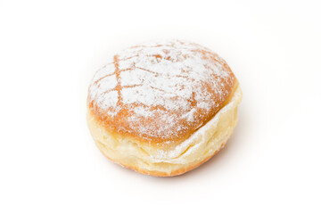 Single isolated Krapfen or Berliner doughnut dusted with icing sugar, traditional German fried Brioche dough pastry filled with vanilla custard for New Year's or carnival party on white background - 556941506