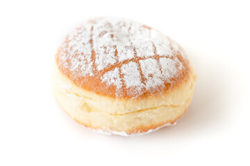 Single isolated Krapfen or Berliner doughnut dusted with icing sugar, traditional German fried yeast dough pastry filled with vanilla pudding for New Year's or carnival party on white background - 556941538