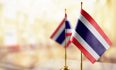 Small flags of the Thailand on an abstract blurry background