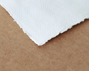 hand torn deckled edge art watercolor felt paper on brown simple background 