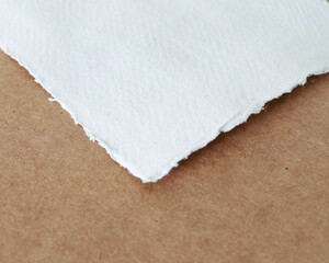 hand torn deckled edge art watercolor felt paper on brown simple background 