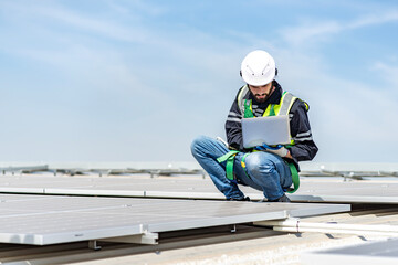 Male engineer installing or checking the working condition of solar panels on the roof or at the height of the factory for saving electricity was broken to use renewable energy from the sun