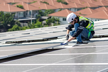 Male engineer installing or checking the working condition of solar panels on the roof or at the height of the factory for saving electricity was broken to use renewable energy from the sun