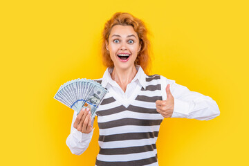 rich woman with money at studio, thumb up. photo of rich woman with money.