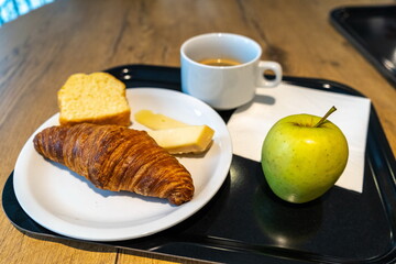 Hotel Breakfast with Croissant, Coffee, Cheese and Apple