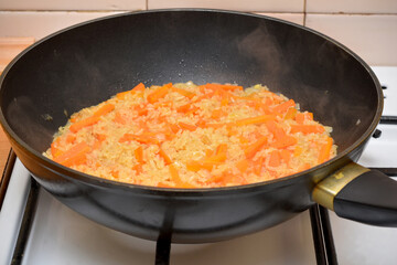 Asian cuisine, rice with vegetables in a frying pan