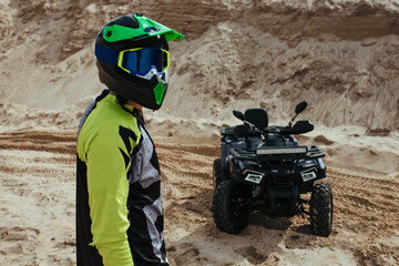 Kanshik stands near the ATV. extreme and sports concept