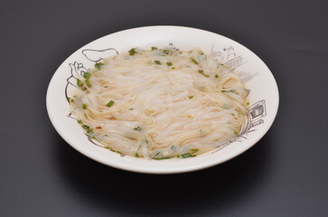 bowl with instant rice noodles on black background close-up