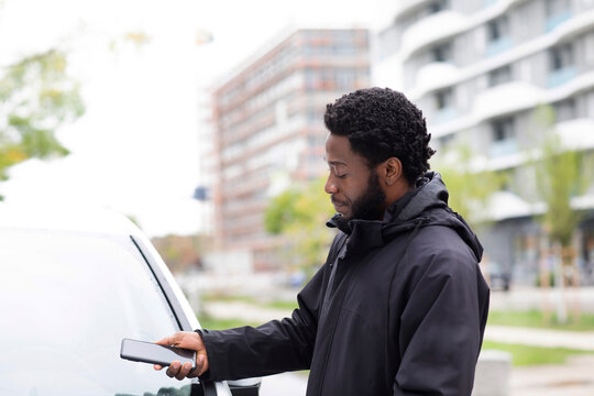 Man using mobile app for renting car