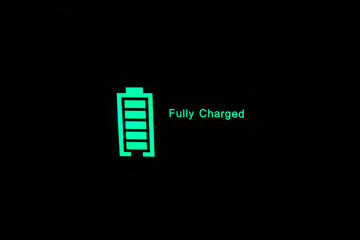 "Fully charged" Glowing green battery charge indicator. Fast charging technology.
