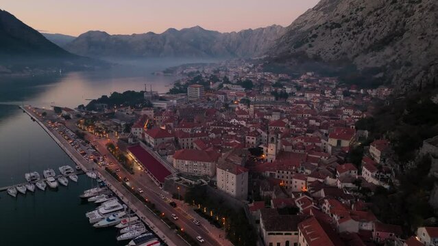 Fly over the evening Kotor city, aerial view. New Year and christmas eve