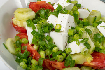 Greek Salad in White Bowl, Macro Photo of Fresh Garden Salat, Salad with Green Onion, Feta,...