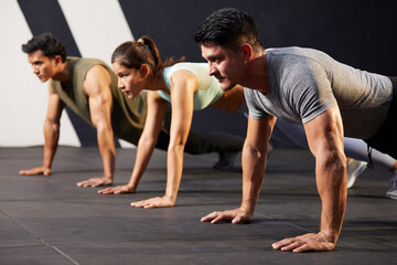 young athletic man doing push up with on the gym floor