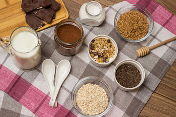 Homemade granola with nuts  and other ingredients on a wooden board. Healthy breakfast concept, vegetarian breakfast