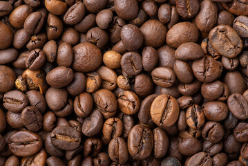 Close up of roasted coffee beans. Dark aromatic coffee grain before grinding