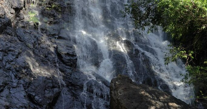 Close Up Tilt of Big Waterfall in Rainforest with Trees and Rocks 4K