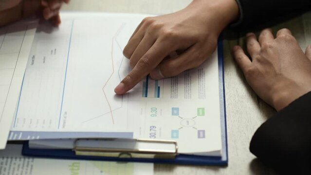 teamwork group meeting explain data graph diagram and Hand forefinger point to drawing graph explaining new idea for business improvement to workmate project team.	