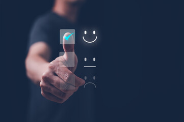 Customer service satisfaction survey concept.Business people or customers show satisfaction by pressing face emoticon smile in satisfaction on virtual touch screen.