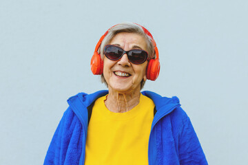 colorful dressed senior female citizen with positive attitude and a cool happy smile wearing...