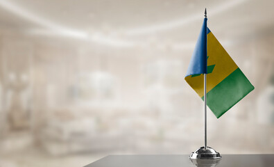 A small Saint Vincent flag on an abstract blurry background