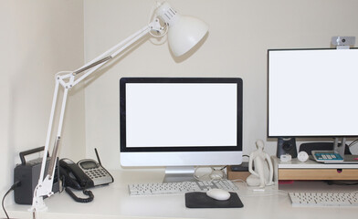 Lived in workstation set up with phone lamp desktop computers