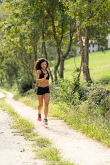 Fototapeta na wymiar Trail running smiling girl runs uphill and on trail 