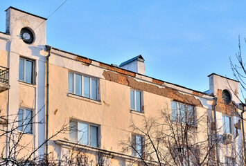 Fragment of the facade of an old residential building on a winter day