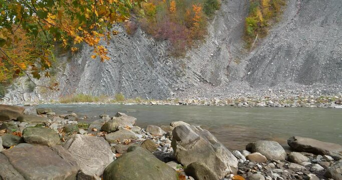 Beautiful autumn nature. The Prut river and mountain folds in Yaremche City, Carpathians, western Ukraine, known as Yaremche folds - biggest outcrop of Stryi formation in Europe