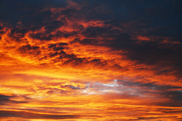 Dramatic sky. Red sunset with dark clouds.