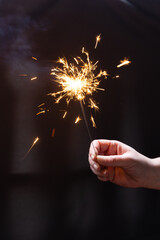 hand with sparkler - 556973738