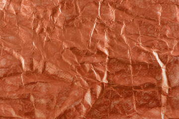 Red paper foil wrinkled or crumpled abstract background.