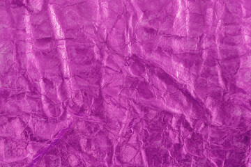 Purple paper foil wrinkled or crumpled abstract background.